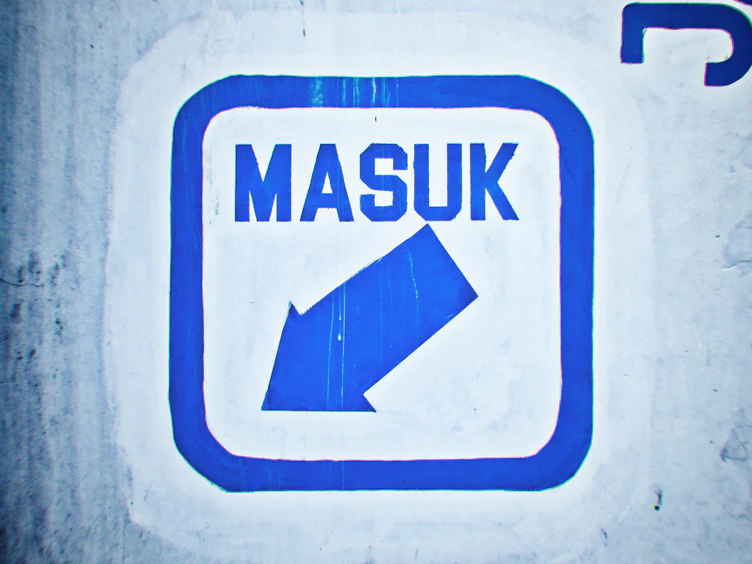 Blue and white directional sign with arrow and MASUK for your brand mascot ideas