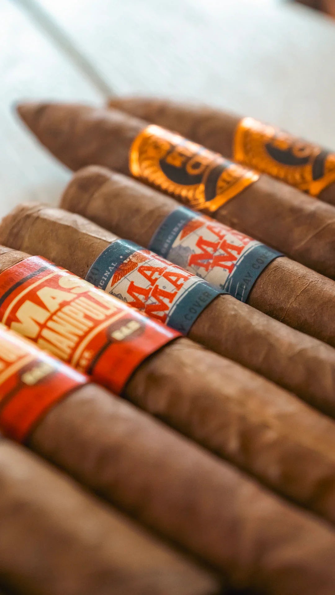 Vintage Cuban cigars with orange blue bands and embossed labels