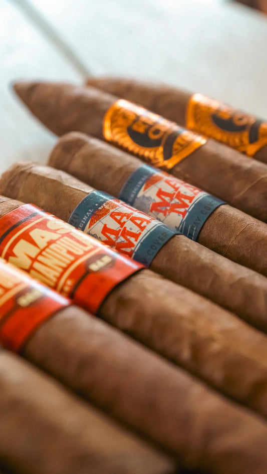 Vintage Cuban cigars with orange blue bands and embossed labels
