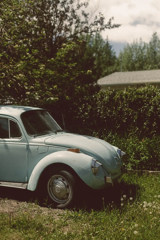Vintage light blue Volkswagen Beetle showcasing timeless design elements from bygone era