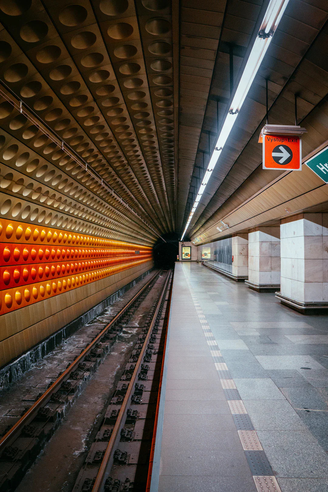 Underground Railroad station platform with curved ceiling and orange lights