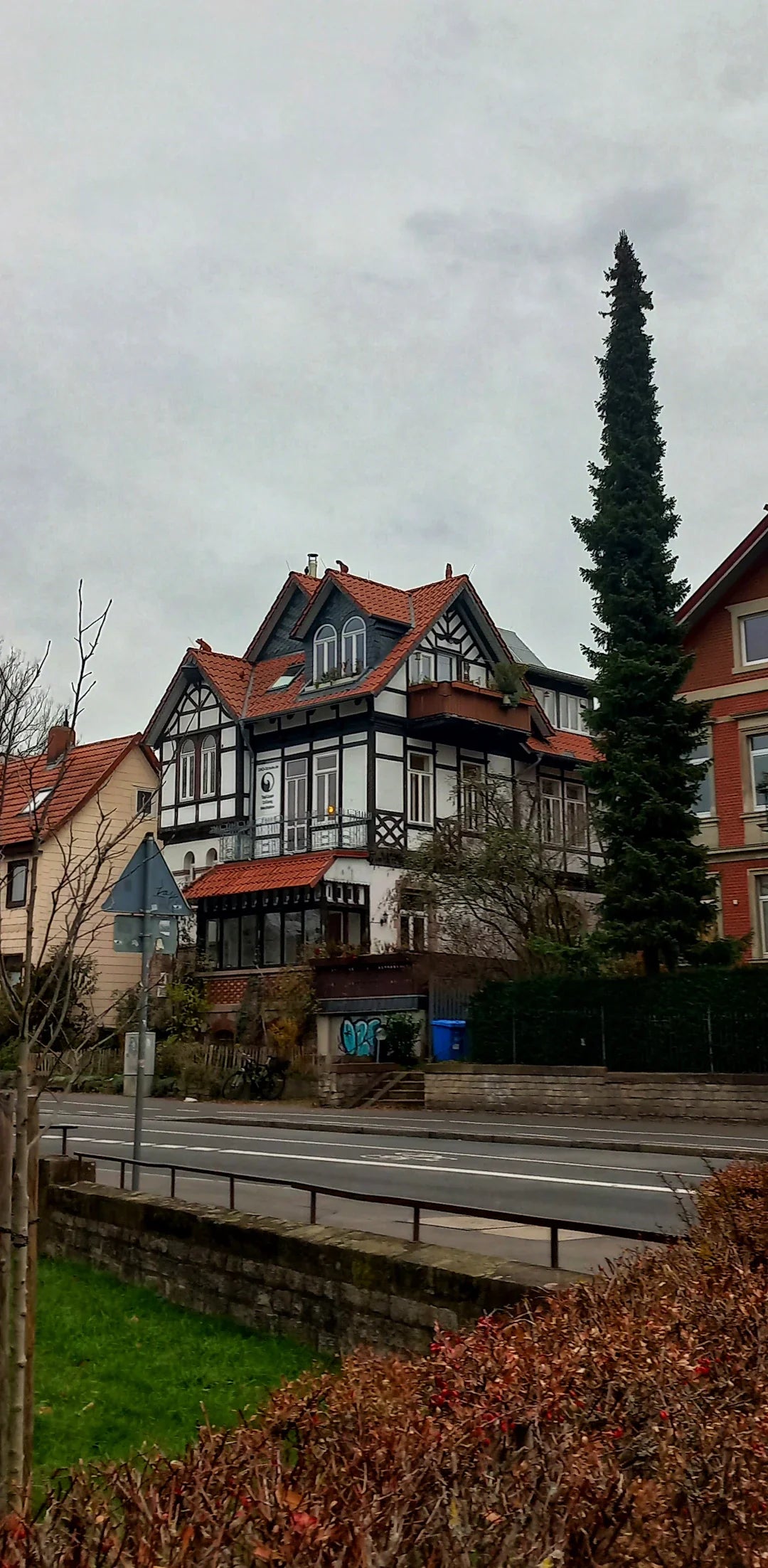 Traditional red brick house with black roof and white trim in WWII homefront war effort