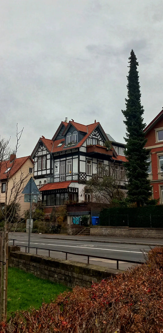 Traditional red brick house with black roof and white trim in WWII homefront war effort