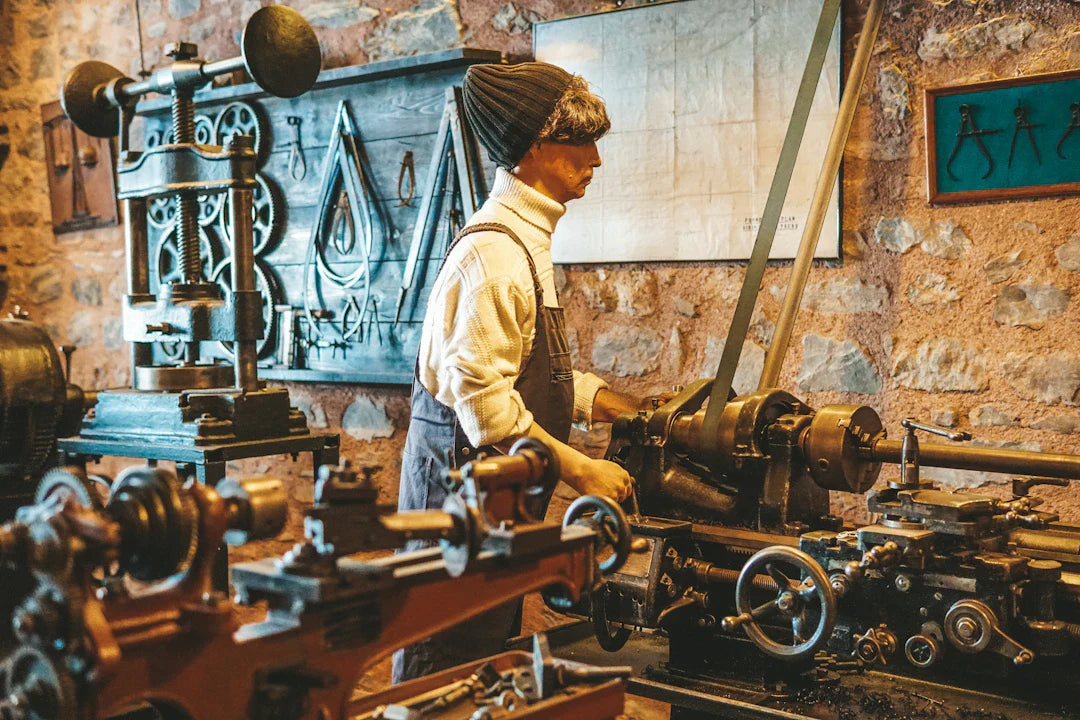 Male mannequin operating vintage metalworking lathe showcasing 19th century manufacturing techniques