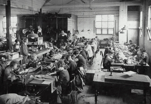 Women working in a busy garment factory during The Gilded Age industrial shift