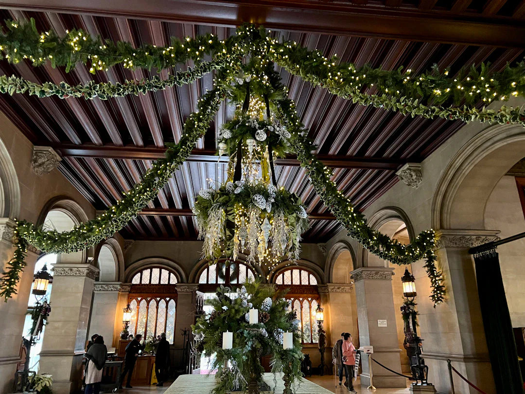 Gilded Age grand hall with elaborate Christmas decorations