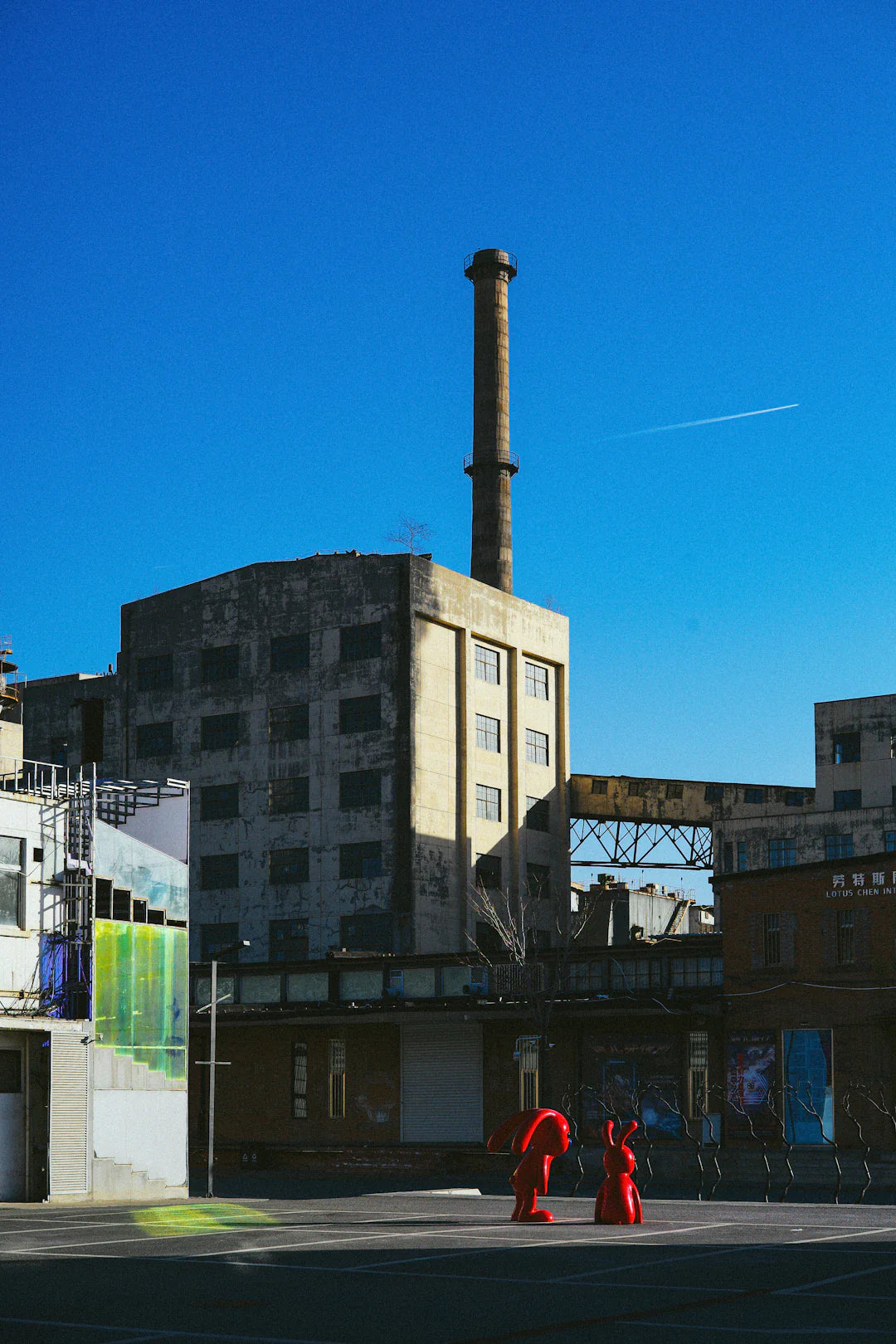 Weathered industrial America building with smokestack, showing how advertising agencies shaped consumer culture