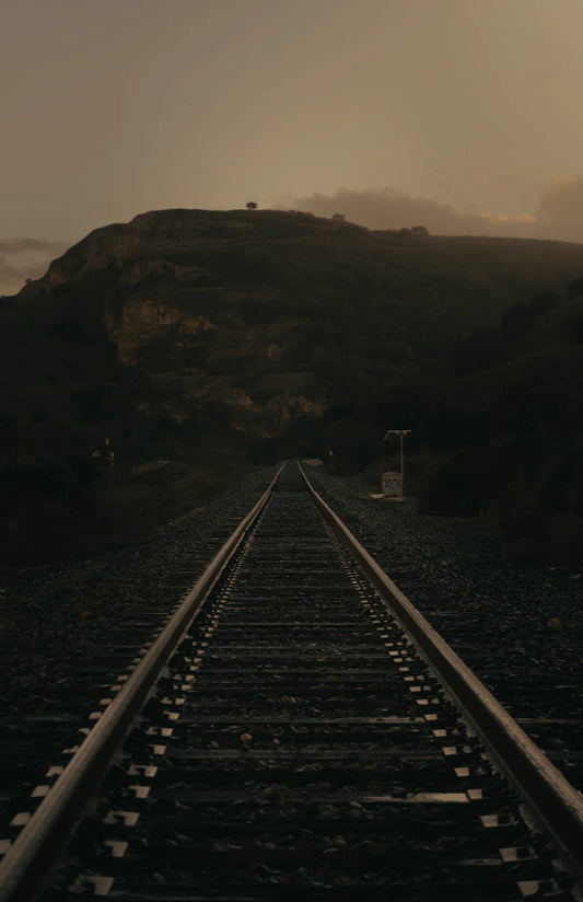 Long transcontinental railroad tracks symbolize American economic growth and environmental impact