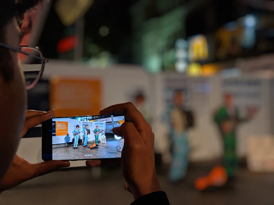Person holding smartphone showing augmented reality scene for interactive packaging or AR billboards