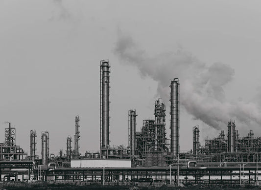 Industrial refinery with towers and chimneys illustrating technological innovations in the industrial revolution