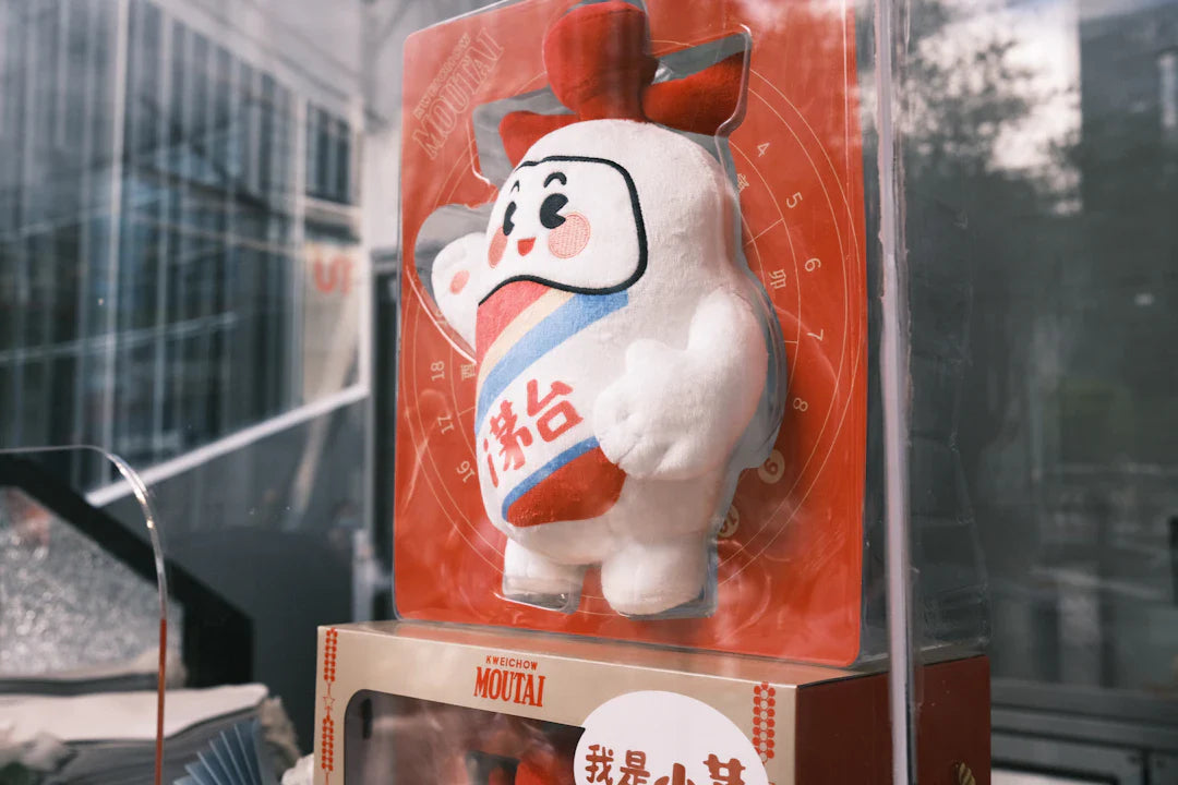 White plush vintage mascot with red and blue accents, similar to Pillsbury Doughboy or Michelin Man