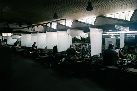 Workers at factory stations in mass production era
