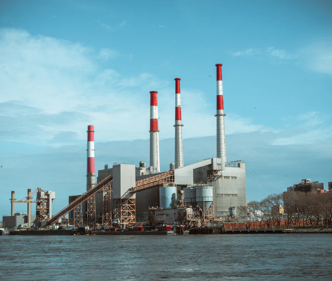 Industrial power plant with smokestacks on waterfront showcasing America’s industrial growth