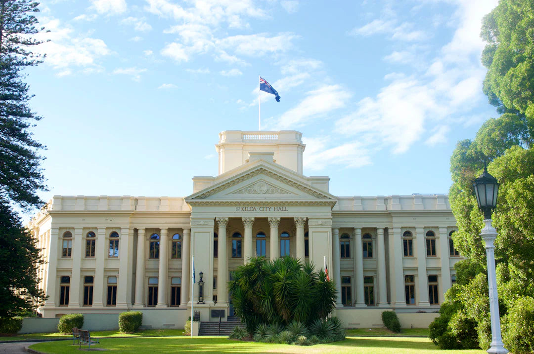 Grand classical building with flag symbolizing government role in fair competition and environmental protection