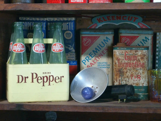 Vintage Dr Pepper bottles with antique labels in a wooden crate