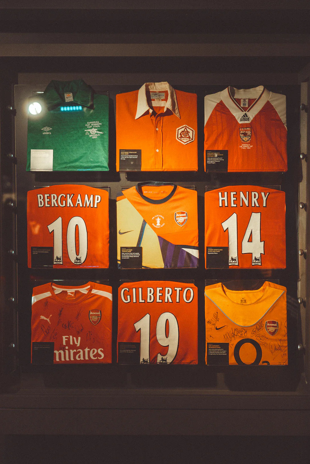 Unique Arsenal autographed jerseys with Bergkamp, Henry, Gilberto names