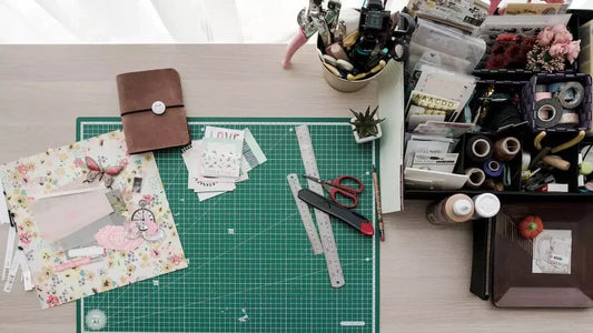 Crafting workspace with tools and supplies for vintage memorabilia and vinyl records