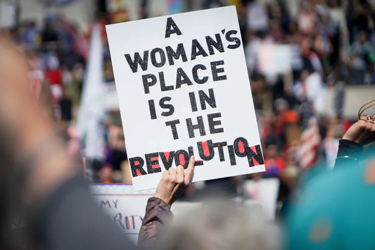 White protest sign with red accents on women’s rights in American Revolution