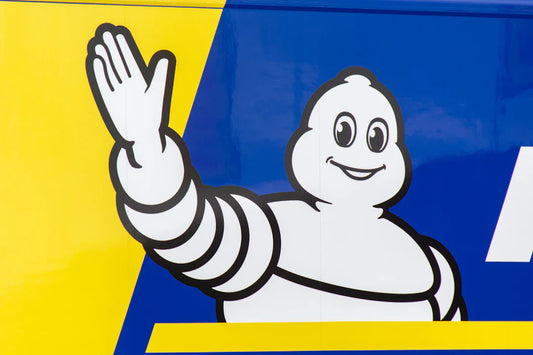 Smiling cartoon tire mascot with retro colors, inspired by vintage brand mascots