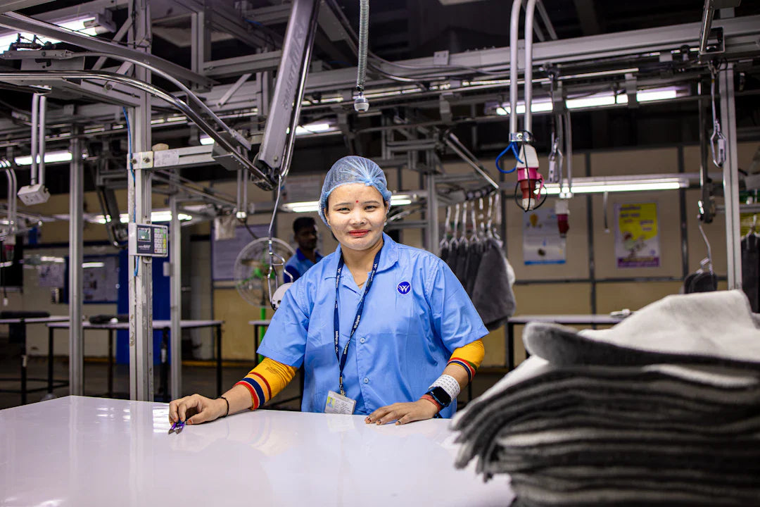 Smiling woman in light blue uniform symbolizes women’s contributions to workforce equality