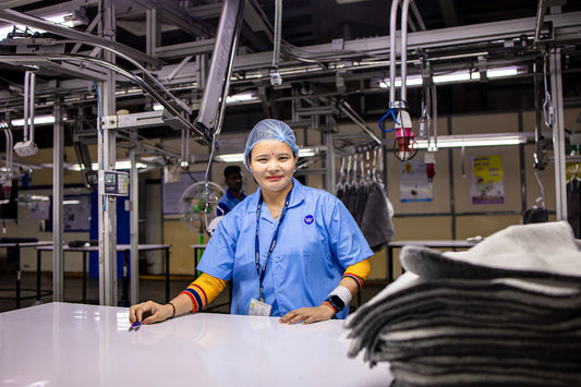Smiling woman in light blue uniform symbolizes women’s contributions to workforce equality