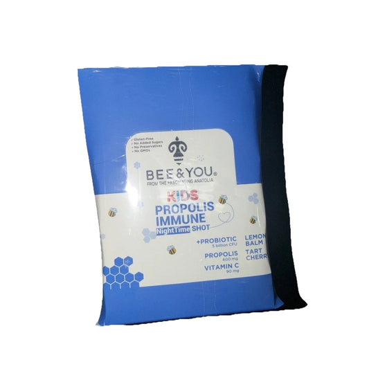 Blue and white cardboard box of Bee & You Kids Propolis Immune Nighttime Shot with bee graphics and ingredient information, angled three-quarter view.
