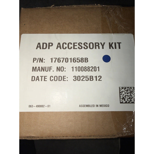 Cardboard shipping box with white label displaying ADP Accessory Kit product details, part number, and manufacturing information.
