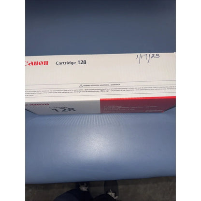 Canon 128 black toner cartridge in white red packaging with markings