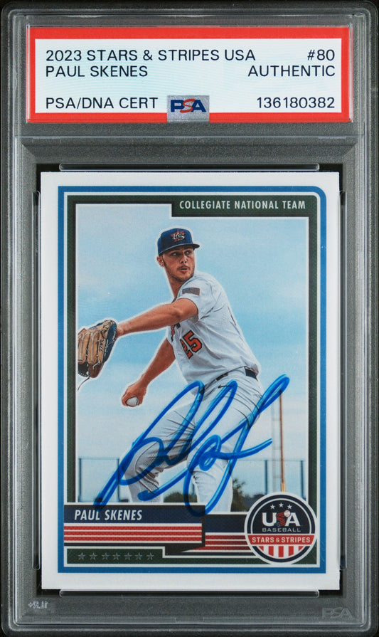 Graded baseball card in clear case showing Paul Skenes in white uniform with blue autograph signature across chest area.