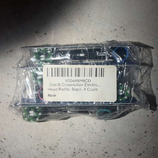 Sealed plastic package containing four black Oral-B CrossAction electric toothbrush head refills with product label and barcode visible.