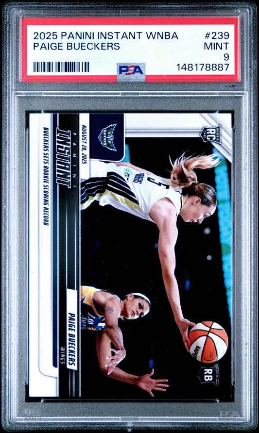 PSA graded Paige Bueckers rookie basketball card in clear case showing two players on court with red stripe grading label.