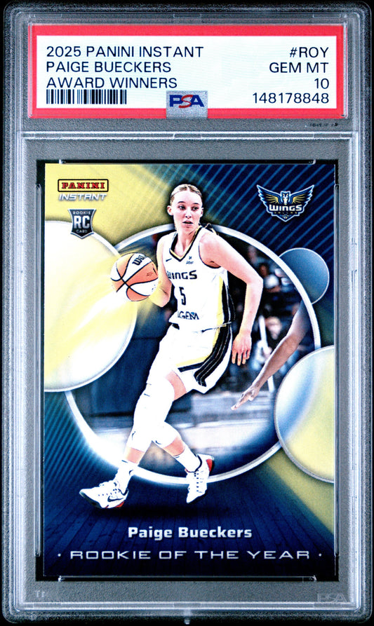 PSA-graded basketball card in clear plastic case showing Paige Bueckers in white Wings uniform dribbling ball against blue background.
