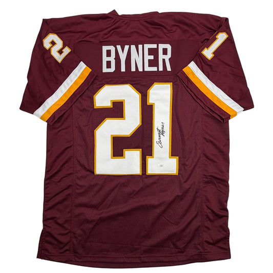 Maroon football jersey with "BYNER" and number 21 in white and gold lettering, displayed flat against white background.