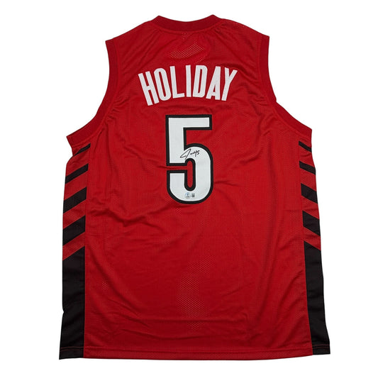 Back view of red Portland basketball jersey number 5 with "HOLIDAY" nameplate and autographed number, black side panels.