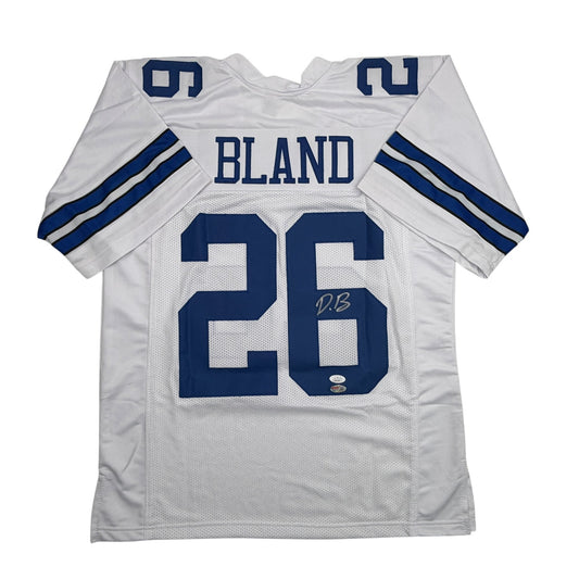 White Dallas Cowboys football jersey number 26 with "BLAND" nameplate, displayed flat front view showing mesh fabric and navy blue stripes on sleeves.