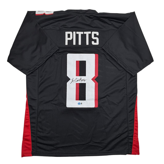 Back view of black and red Kyle Pitts football jersey with white number 8 and autographed signature.