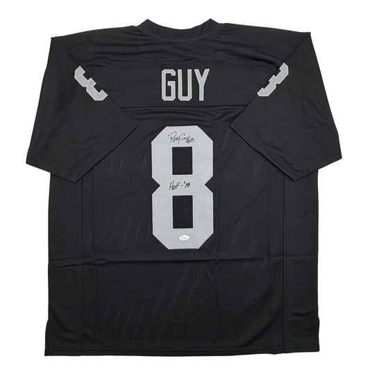 Black football jersey with white number 8 and "GUY" nameplate, displayed flat showing back view with visible signatures and HOF '14 inscription.