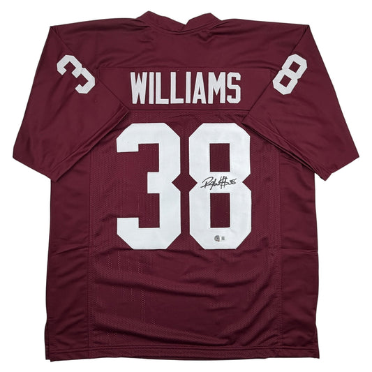 Maroon Oklahoma college football jersey displaying "WILLIAMS" and number 38 on back with white numerals and signature.