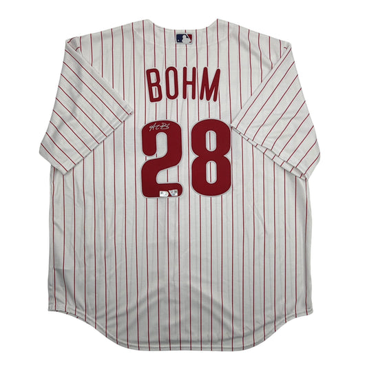 Front view of white pinstriped baseball jersey with "BOHM" and number "28" in red, featuring autograph on number.