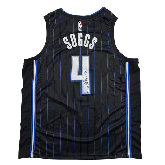 Back view of black pinstriped Orlando Magic basketball jersey with blue trim, number 4, "SUGGS" nameplate, and autographed signature.