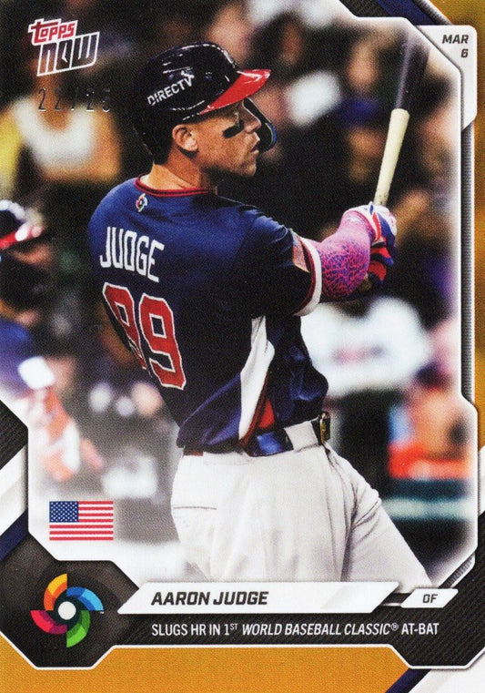 Aaron Judge in Team USA navy uniform mid-swing during World Baseball Classic game, card front with orange foil border.