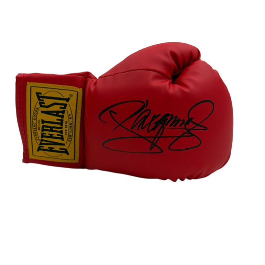 Red Everlast boxing glove with gold and black cuff label, displaying black signature on the glove's surface, shown from side angle.