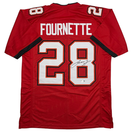 Back view of red Leonard Fournette Tampa Bay football jersey number 28 with white lettering and signature.