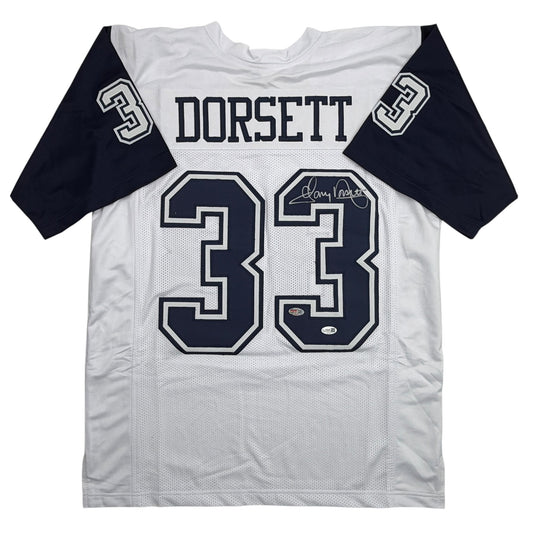 White and navy Dallas Cowboys football jersey number 33 with "DORSETT" nameplate and autograph, displayed flat front view.