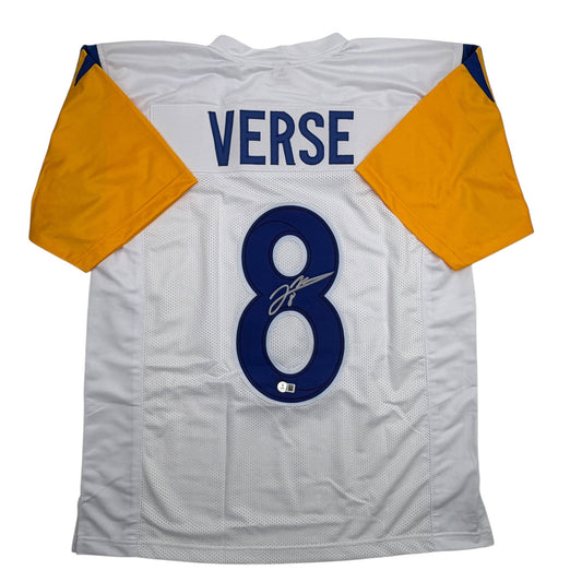 White football jersey with yellow and navy sleeves, navy number 8, "VERSE" text, and autographed signature visible, flat lay front view.
