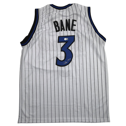 Back view of white pinstriped basketball jersey with "BANE" and blue number 3, navy trim, and visible autograph on number.