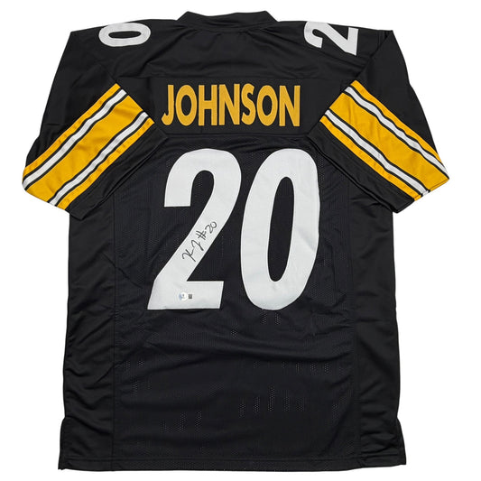 Back view of black Pittsburgh football jersey number 20 with "JOHNSON" nameplate, yellow and white striped shoulders, featuring autograph on chest.