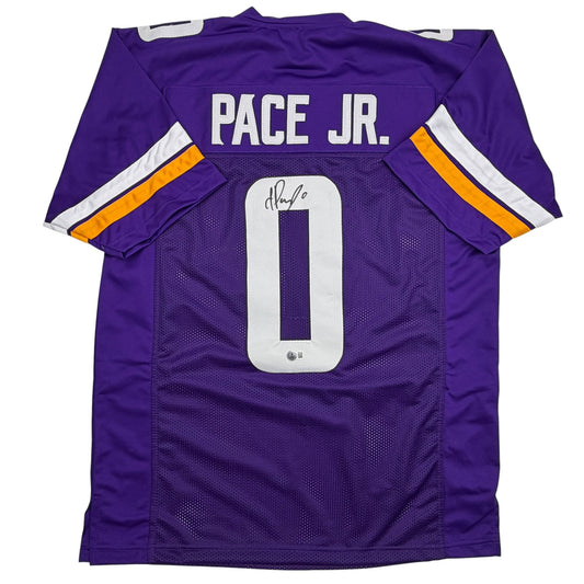 Purple Minnesota Vikings jersey displayed flat showing back with "PACE JR." nameplate, number 0, and autograph, featuring white and gold sleeve stripes.