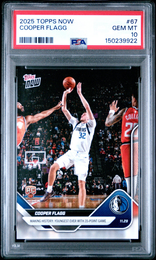 Graded PSA 10 Gem Mint basketball card in clear plastic case showing Cooper Flagg shooting over defenders in white Mavericks uniform.