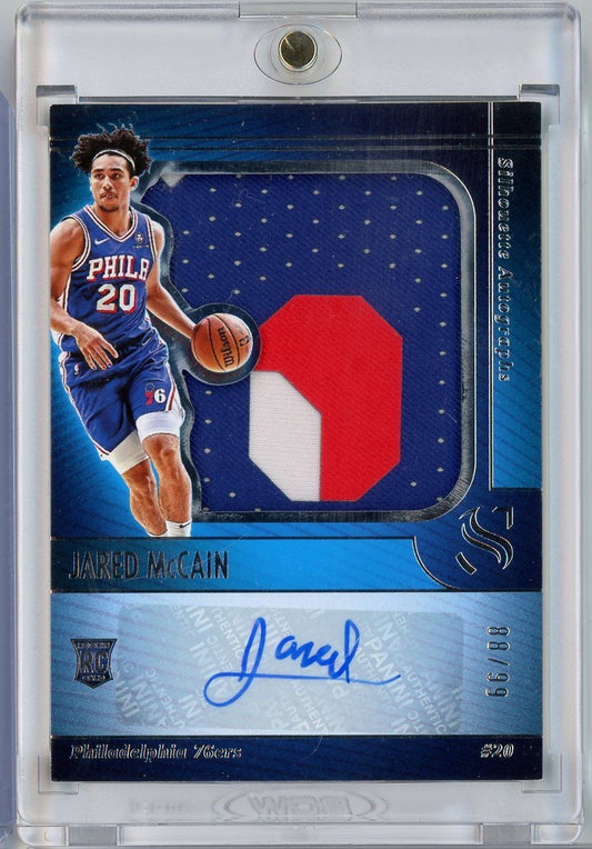 Front of slabbed basketball card showing Jared McCain in Philadelphia 76ers uniform with red and white silhouette patch and blue autograph.
